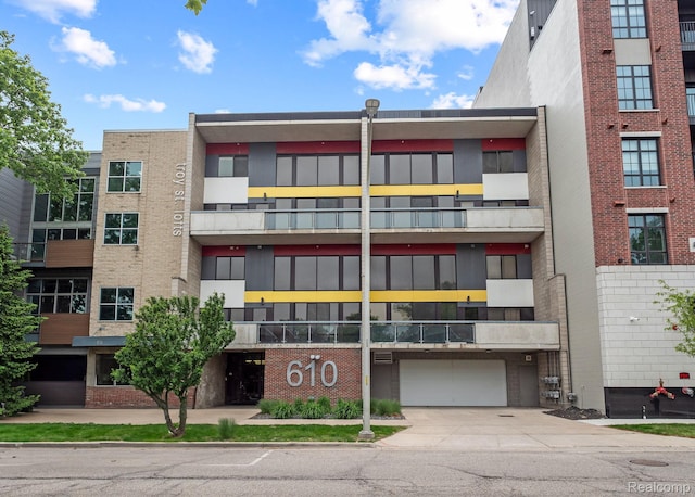 610 S Troy St, Royal Oak, MI 48067 - view of apartment building / complex with concrete driveway and a garage