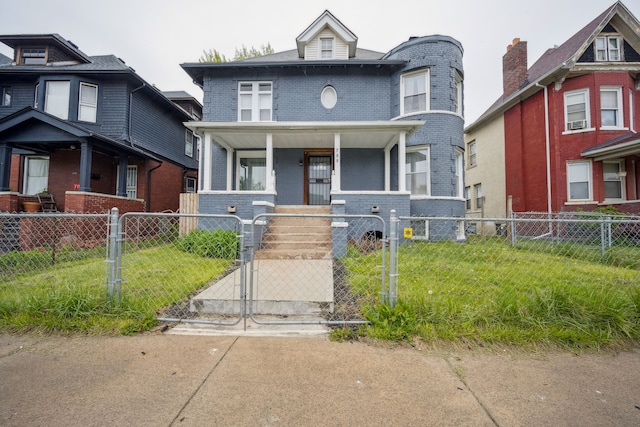700 W Euclid St, Detroit, MI 48202 - view of front of house featuring covered porch, a gate, brick siding, a front yard, and a fenced front yard
