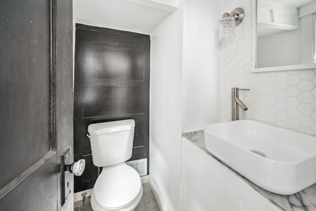 700 W Euclid St, Detroit, MI 48202 - bathroom with tile walls, toilet, and a sink