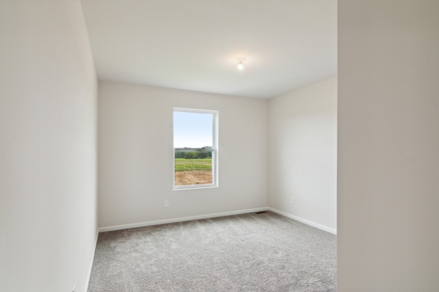 spare room with carpet floors and baseboards