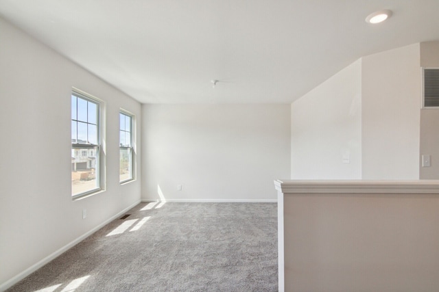unfurnished room featuring carpet floors and baseboards