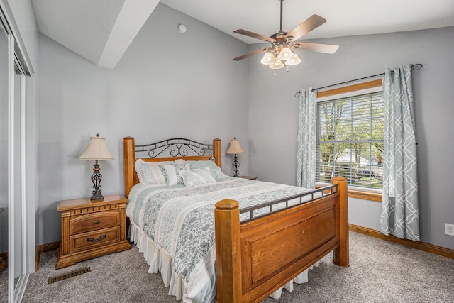 bedroom featuring light colored carpet, visible vents, baseboards, vaulted ceiling, and a closet