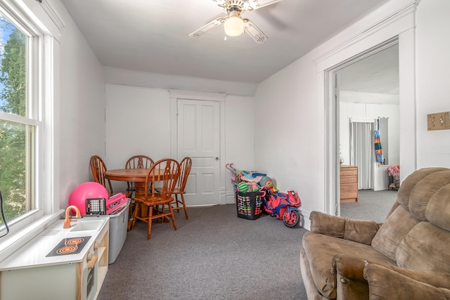 recreation room with carpet flooring and ceiling fan