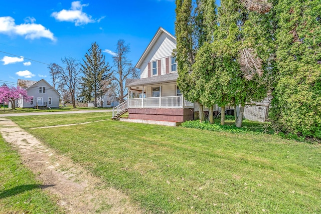exterior space with covered porch and a front yard