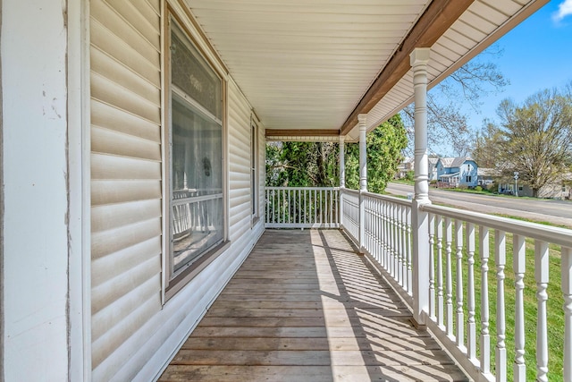 wooden terrace featuring covered porch