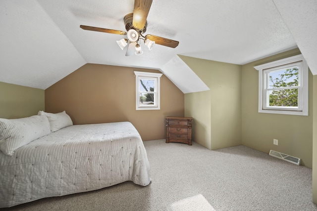 bedroom featuring visible vents, carpet flooring, ceiling fan, and lofted ceiling