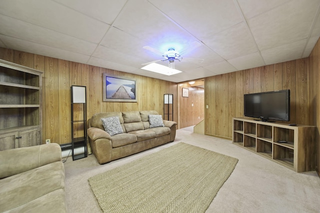 carpeted living room with wooden walls