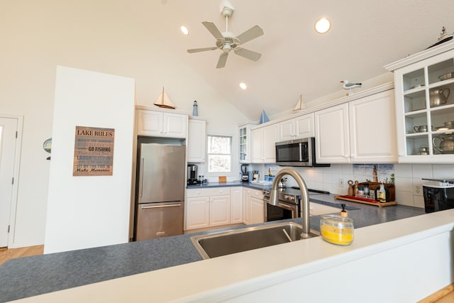 kitchen with ceiling fan, stainless steel appliances, recessed lighting, tasteful backsplash, and glass insert cabinets