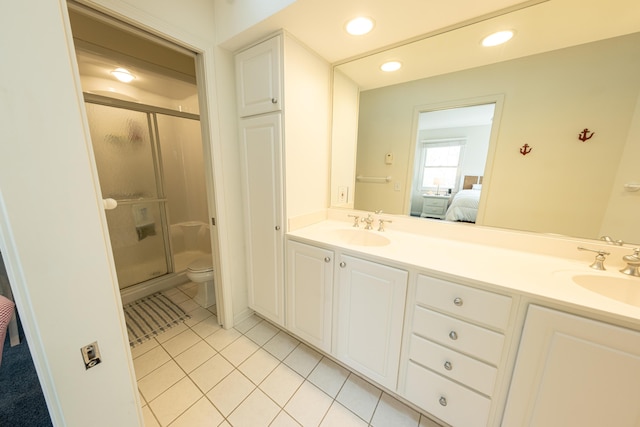 bathroom with tile patterned floors, a sink, and a stall shower