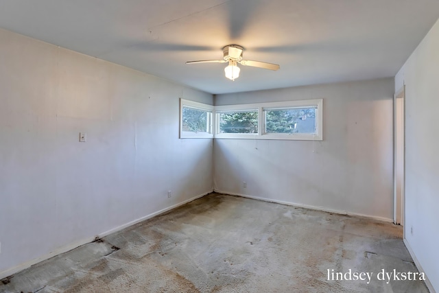carpeted spare room with baseboards and a ceiling fan