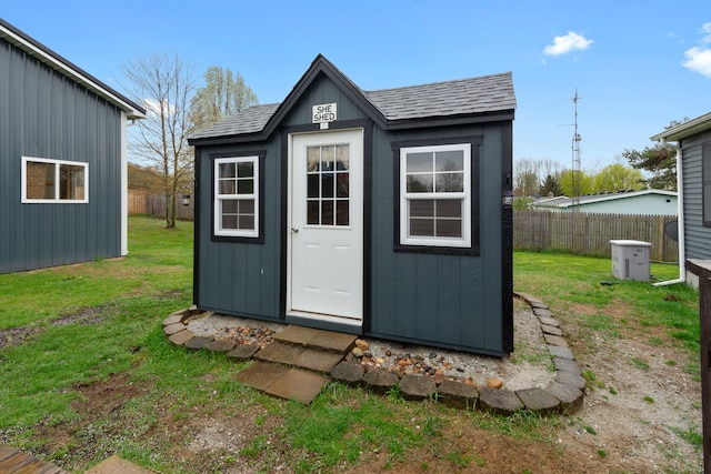 view of shed with fence