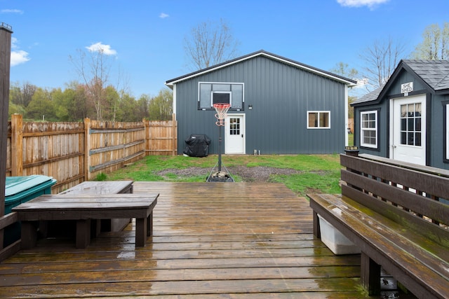 wooden deck featuring fence, an outbuilding, and grilling area