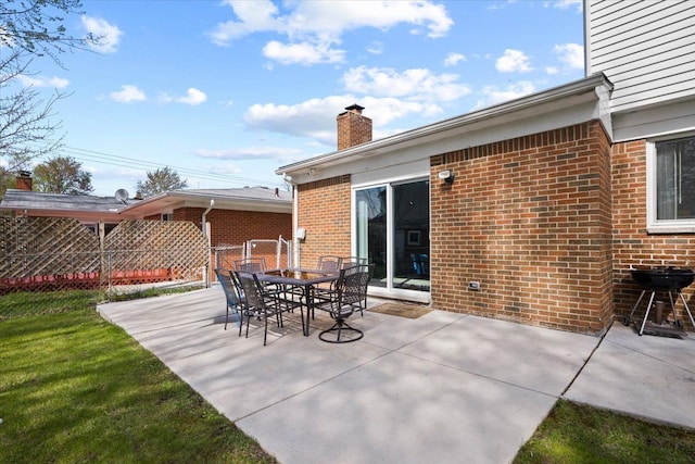 view of patio with outdoor dining area and fence