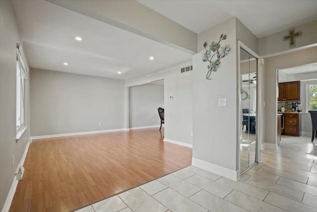 spare room with visible vents, recessed lighting, light wood-style floors, and baseboards
