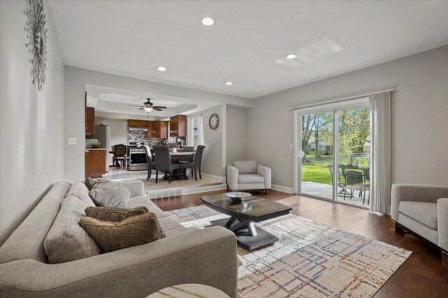 living room featuring dark wood-type flooring, recessed lighting, and a wealth of natural light