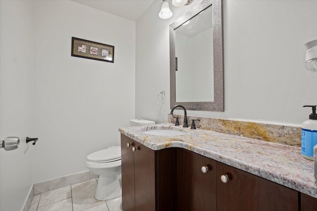 bathroom featuring vanity, tile patterned flooring, and toilet