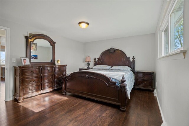 bedroom featuring baseboards and wood finished floors