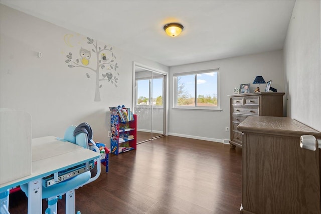 playroom with baseboards and dark wood-style floors