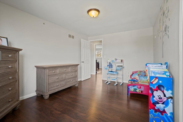 playroom with visible vents, dark wood finished floors, and baseboards