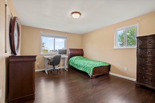 bedroom with baseboards and wood finished floors