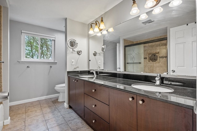 bathroom with toilet, baseboards, visible vents, and a sink