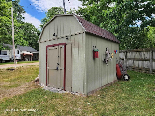 view of shed featuring fence