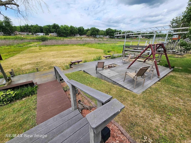 view of jungle gym with a yard and a deck