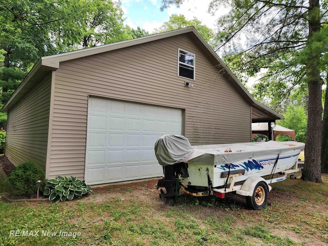 view of property exterior featuring an outbuilding and a detached garage