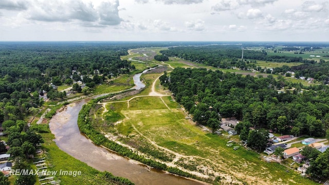 birds eye view of property with a view of trees