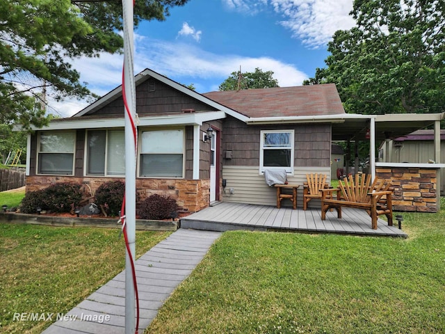 back of property featuring a yard and a wooden deck