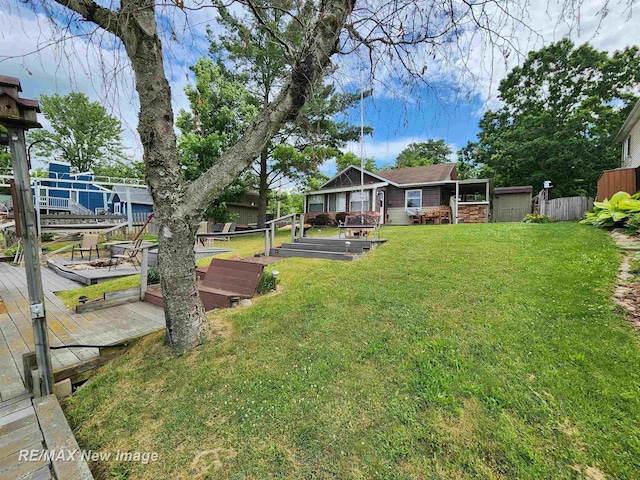 view of yard with fence and a wooden deck