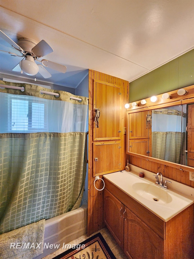 bathroom featuring shower / bath combo with shower curtain, ceiling fan, and vanity