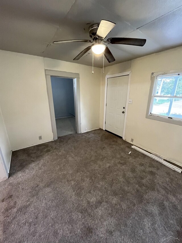 635 S 16th St, Saginaw, MI 48601 - empty room with ceiling fan, a baseboard heating unit, and dark carpet