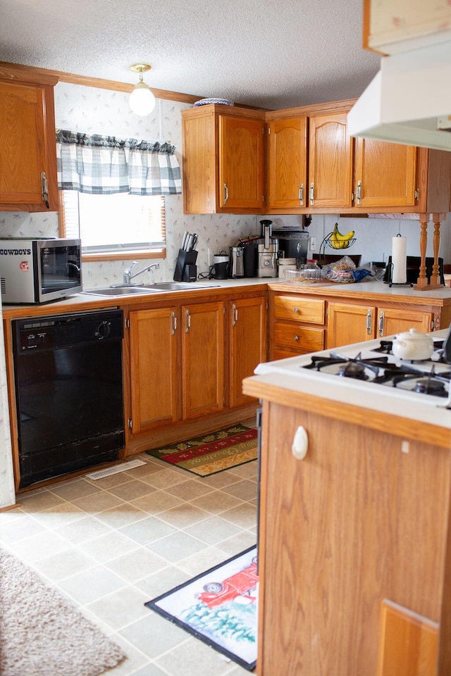 kitchen with wall chimney range hood, dishwasher, a sink, light countertops, and stainless steel microwave