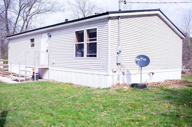 view of home's exterior with a yard