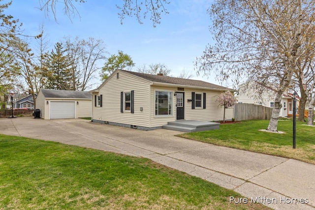 bungalow featuring concrete driveway, fence, an outdoor structure, and a front lawn