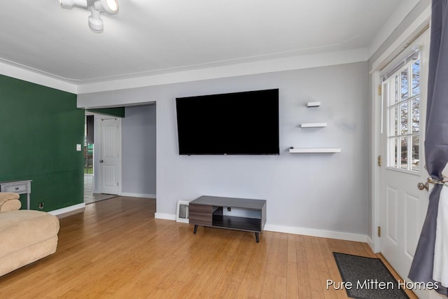 living room with baseboards and wood finished floors