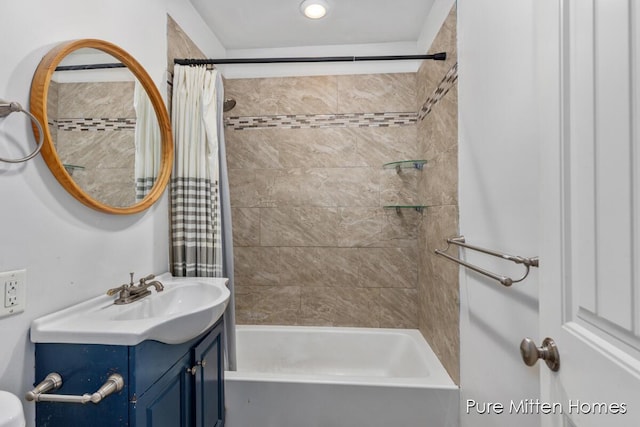 full bath featuring vanity and shower / bath combo with shower curtain