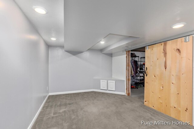 finished below grade area featuring carpet flooring, recessed lighting, and baseboards
