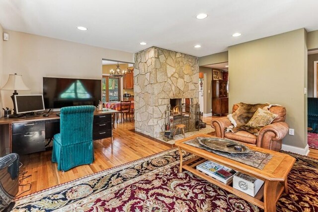 6460 E Galien Buchanan Rd, Buchanan, MI 49107 - living area featuring an inviting chandelier, recessed lighting, wood finished floors, and a fireplace