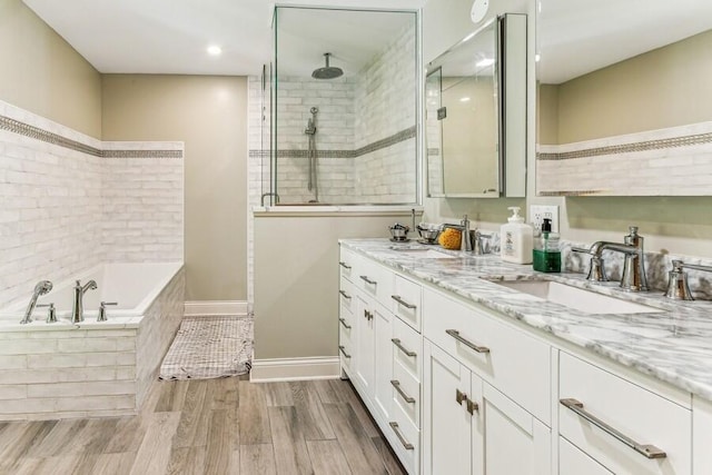 6460 E Galien Buchanan Rd, Buchanan, MI 49107 - full bath featuring double vanity, a garden tub, wood finished floors, a sink, and tiled shower