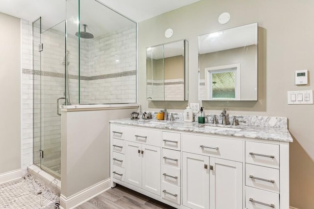 6460 E Galien Buchanan Rd, Buchanan, MI 49107 - bathroom with double vanity, a sink, baseboards, and a stall shower