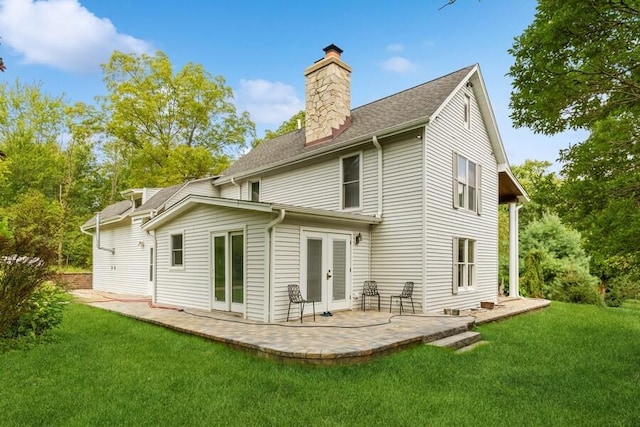 6460 E Galien Buchanan Rd, Buchanan, MI 49107 - rear view of house featuring a lawn, a patio area, french doors, and a chimney