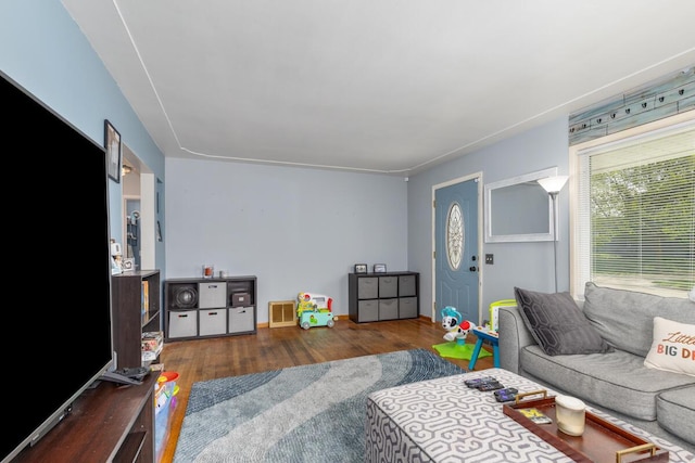 living area with wood finished floors and visible vents