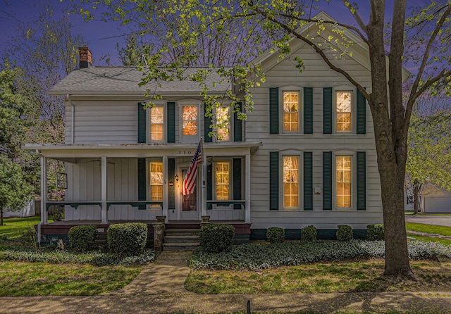 310 E Unadilla St, Pinckney, MI 48169 - colonial home featuring a porch and a chimney