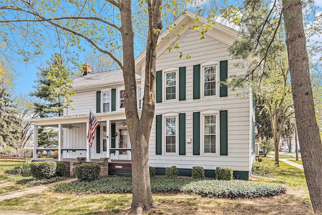 310 E Unadilla St, Pinckney, MI 48169 - view of front of property with a ceiling fan, a chimney, a porch, and board and batten siding