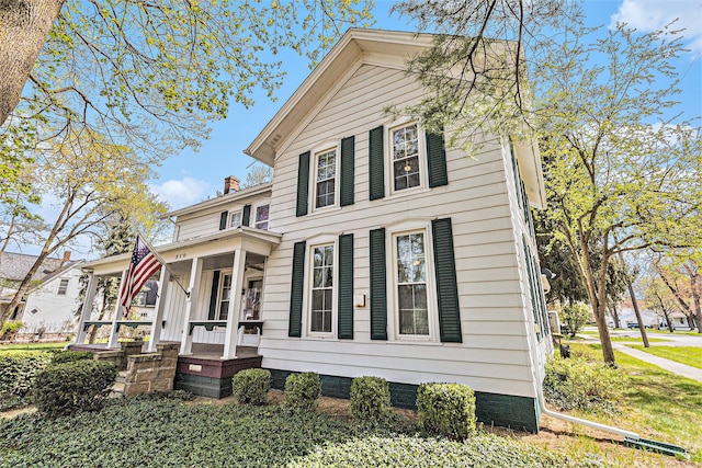 310 E Unadilla St, Pinckney, MI 48169 - greek revival house featuring a chimney, a porch, and crawl space