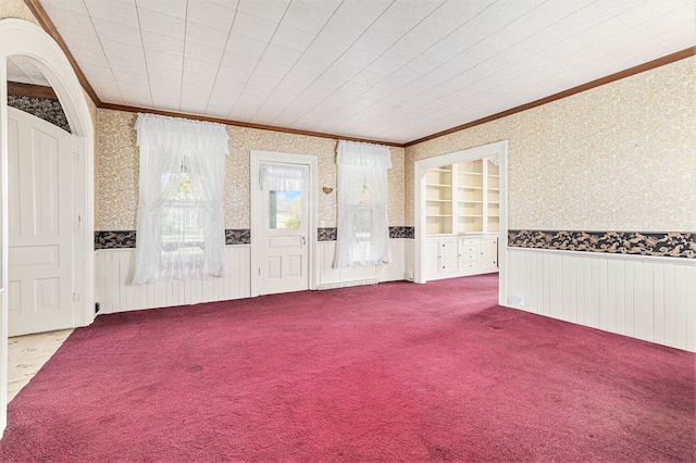 310 E Unadilla St, Pinckney, MI 48169 - spare room with wallpapered walls, ornamental molding, carpet, and a wainscoted wall