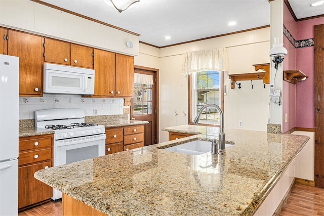 310 E Unadilla St, Pinckney, MI 48169 - kitchen featuring white appliances, crown molding, a sink, and light wood-type flooring