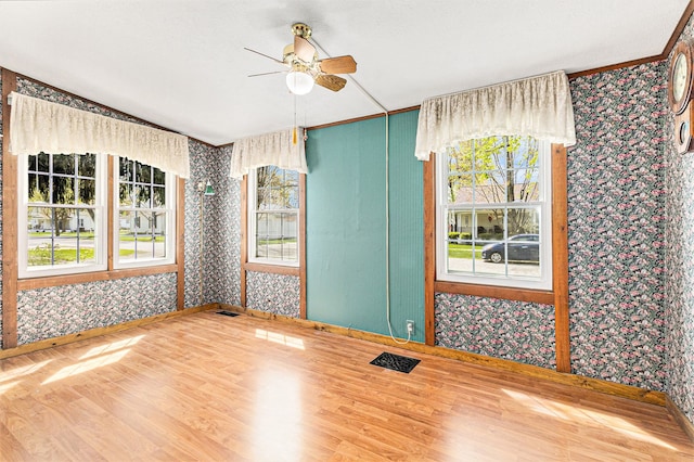 310 E Unadilla St, Pinckney, MI 48169 - spare room featuring baseboards, a ceiling fan, and wallpapered walls